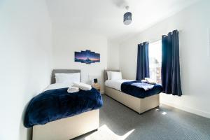 a bedroom with two beds and a window at Ohemaa - Garden-Close to Hull City Centre&Hull Uni in Hull