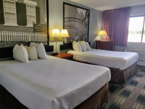 a hotel room with two beds and a window at Sprucewood Inn in Elyria +20 photos