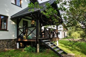 a house with a staircase leading up to it at Dwerniczek 7 in Dwerniczek