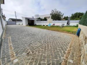 a stone driveway in front of a house at Alojamento Rio Neiva in Boticas