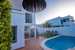 a house with a swimming pool in a yard at Villa Garoed in Playa Blanca