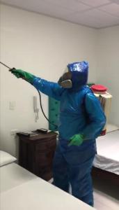a person in a room wearing a blue jumpsuit at Hotel Limaco in Neiva