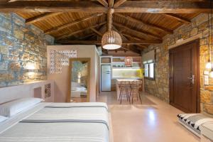 a bedroom with a bed in a room with a kitchen at Fillis House in Vourvourou +53 photos