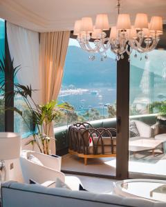 a room with a large window with a chandelier at Boutique Hotel Vissi d'Arte in Budva