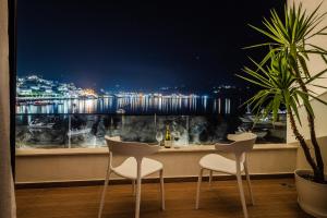 a table and chairs in front of a window with a view at Rea Boutique Hotel in Himare