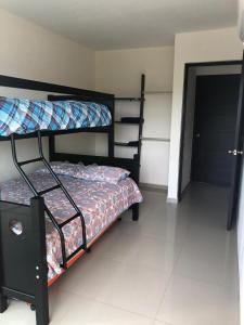 a bedroom with two bunk beds in a room at Departamento Acapulco Diamante in Acapulco