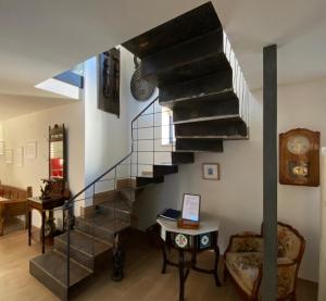 a spiral staircase in a living room with a table at CURATO EL HORNO in Trefacio