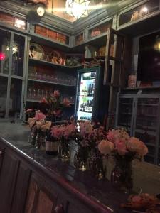 a bar with vases of flowers on a counter at Hotel Boutique Posada XVII in Puebla