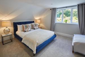 a bedroom with a blue bed and a window at Host & Stay - Prospect Hill Apartments in Whitby