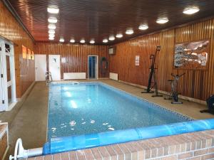 a large swimming pool in a room with a gym at Eastwatch guesthouse in Berwick-Upon-Tweed