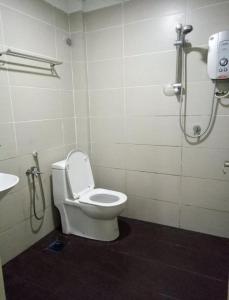 a bathroom with a toilet and a shower stall at Hotel Mutiara KGMMB in Melaka