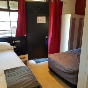 
a bedroom with a bed and a dresser at Motel Lodge in Rockhampton
