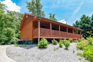a large wooden house with a large deck at EASY LIVIN - SECLUDED FAMILY LOG CABIN in Sevierville