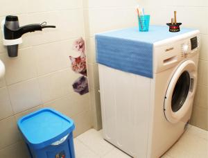 a washing machine in a bathroom with a cat at Magica Bologna in Bologna