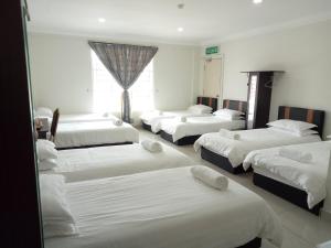 Postel nebo postele na pokoji v ubytování Hotel Mutiara KGMMB, Melaka