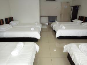 Postel nebo postele na pokoji v ubytování Hotel Mutiara KGMMB, Melaka
