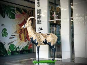 a statue of a giraffe standing in front of a building at Just Sleep Kaohsiung Zhongzheng in Kaohsiung