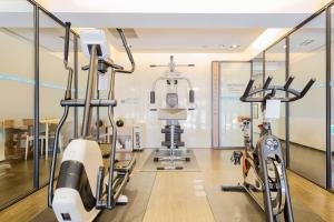 a gym with two treadmills and two bikes at Just Sleep Kaohsiung Zhongzheng in Kaohsiung
