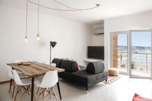 a living room with a table and a couch at Silver Coast - Casa da Água in Foz do Arelho