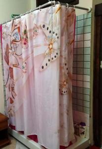 a shower curtain with flowers on it in a bathroom at -= Studio Love =- in Xylophaghou