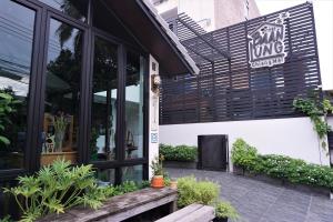 a restaurant with a sign on the side of a building at Baan Lung Poshtel in Chiang Mai