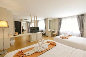 Ένα ή περισσότερα κρεβάτια σε δωμάτιο στο De Hug Hotel & Residence