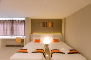Ένα ή περισσότερα κρεβάτια σε δωμάτιο στο De Hug Hotel & Residence