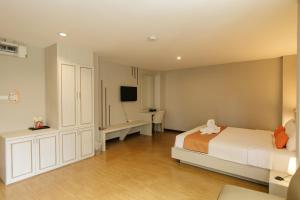 Ένα ή περισσότερα κρεβάτια σε δωμάτιο στο De Hug Hotel & Residence