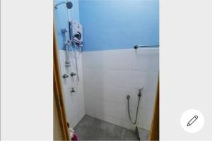 a bathroom with a shower with a glass door at RH Homestay Berhawa Dingin in Kota Bharu