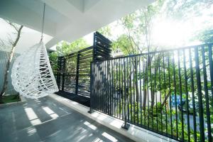 a swing on a balcony with a black fence at 會呼吸的房-採自助式入住-有電梯 in Huwei