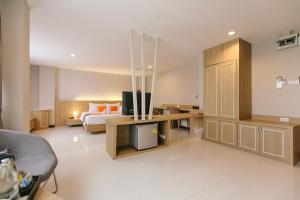 Ένα ή περισσότερα κρεβάτια σε δωμάτιο στο De Hug Hotel & Residence