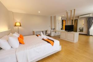 Ένα ή περισσότερα κρεβάτια σε δωμάτιο στο De Hug Hotel & Residence