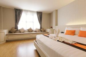 Ένα ή περισσότερα κρεβάτια σε δωμάτιο στο De Hug Hotel & Residence