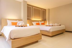Ένα ή περισσότερα κρεβάτια σε δωμάτιο στο De Hug Hotel & Residence