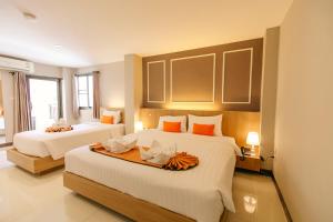 Ένα ή περισσότερα κρεβάτια σε δωμάτιο στο De Hug Hotel & Residence