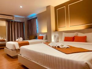 Ένα ή περισσότερα κρεβάτια σε δωμάτιο στο De Hug Hotel & Residence
