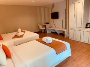 Ένα ή περισσότερα κρεβάτια σε δωμάτιο στο De Hug Hotel & Residence