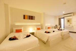 Ένα ή περισσότερα κρεβάτια σε δωμάτιο στο De Hug Hotel & Residence