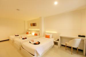 Ένα ή περισσότερα κρεβάτια σε δωμάτιο στο De Hug Hotel & Residence