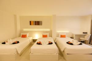 Ένα ή περισσότερα κρεβάτια σε δωμάτιο στο De Hug Hotel & Residence