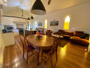 a living room with a wooden table and a couch at The Church at Barrington in Barrington