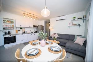 a living room with a table and a couch at Migdalor apartments Tiberias in Tiberias