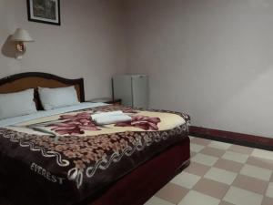 Postel nebo postele na pokoji v ubytování Hotel Parewisata