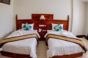Postel nebo postele na pokoji v ubytování Kampong Thom Palace Hotel