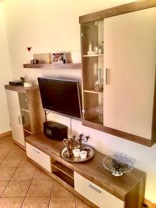 telewizor na drewnianym stole w pokoju w obiekcie Villa Mily w Baskiej Vodzie