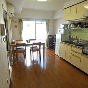 a kitchen with a table and chairs and a dining room at Asayake in Tokyo