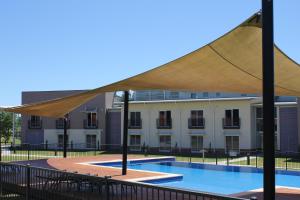 a patio area with a pool table and chairs at Springs Shoalhaven Nowra in Nowra