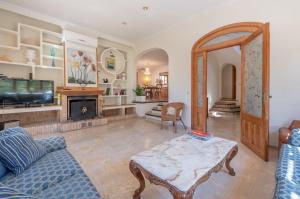 a living room with a couch and a fireplace at Villa Costa De Blanes in Calvià
