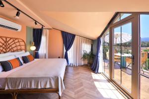 a bedroom with a bed and a balcony at Luff Boutique Hotel - Adult Only in Kas