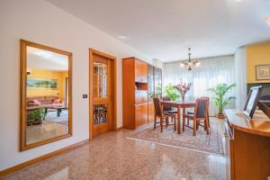 a dining room and living room with a table and chairs at B&B Nonno Carlo in Trento